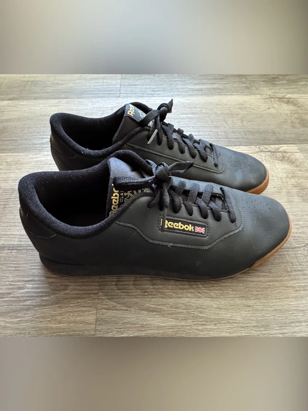 Reebok Women’s Black Sneakers with Gum Outsole and Gold Logo
